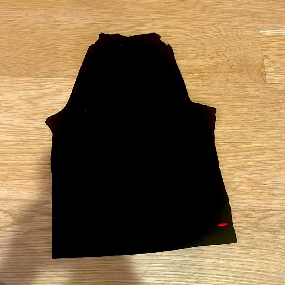 Black turtleneck buttons on the inside small circle on the back